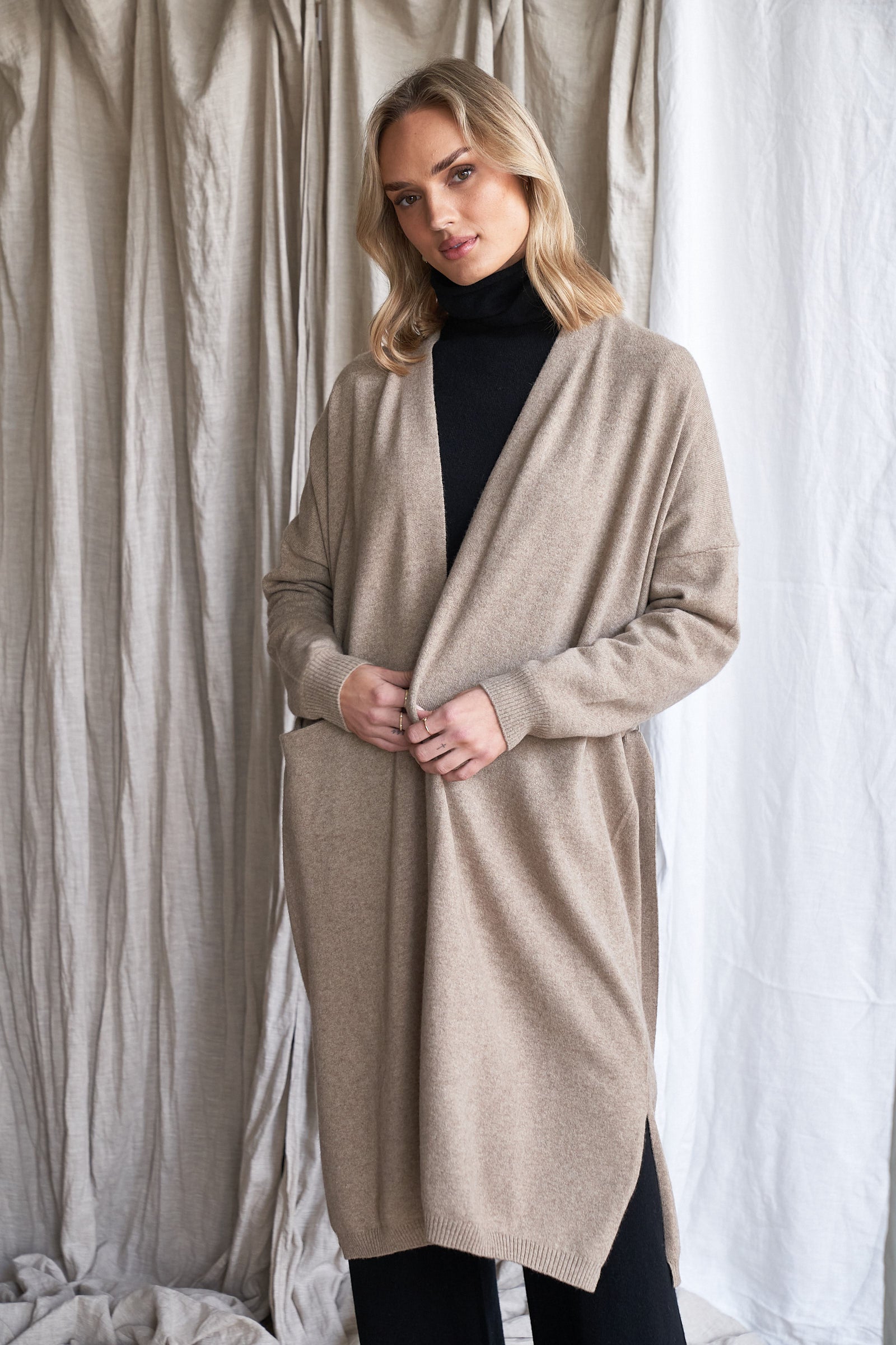 Long Mushroom Cashmere Cardigan with Belt & Pockets – Women’s Coatigan | 100% Pure Cashmere

Wrap yourself in luxury with our long cashmere cardigan in mushroom, designed with a soft belted waist and practical front pockets. Made from 100% pure, ethically sourced cashmere, this elegant coatigan-style knit offers a relaxed, robe-like silhouette perfect for layering during cooler months.

The neutral taupe-grey tone makes it endlessly versatile, while the detachable belt allows for multiple styling options. W