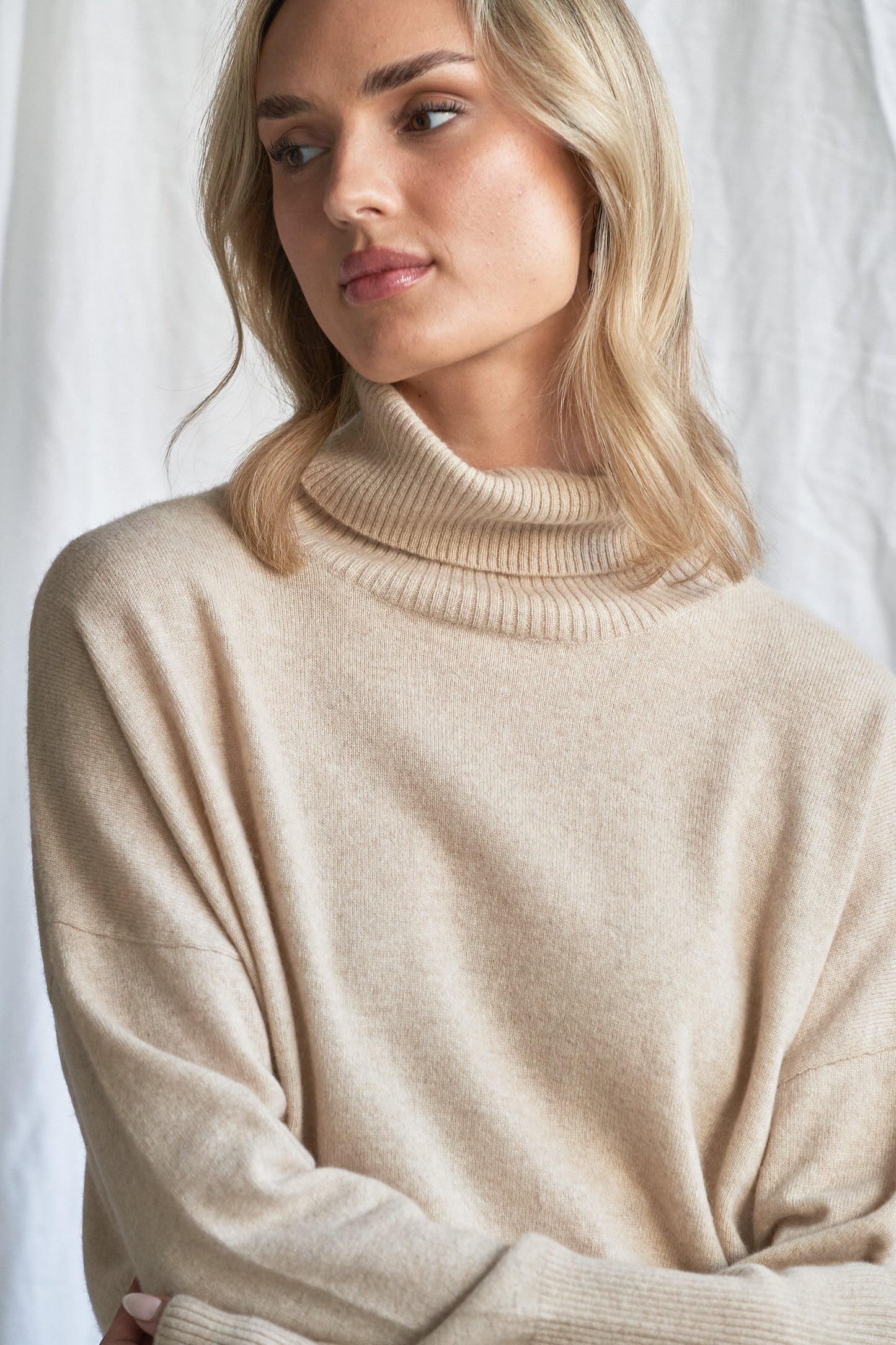 Indulge in the soft luxury of our oversized oatmeal cashmere sweater, designed with a high neckline and relaxed fit for all-day comfort. Made from 100% pure, ethically sourced cashmere, this roomy women’s knit features wide sleeves, drop shoulders, and a soft neutral hue that complements every wardrobe.

Perfect for layering or lounging, this high neck oversized sweater is a modern essential for effortless cold-weather dressing. Soft, breathable, and naturally insulating — it’s winter comfort with elevated 