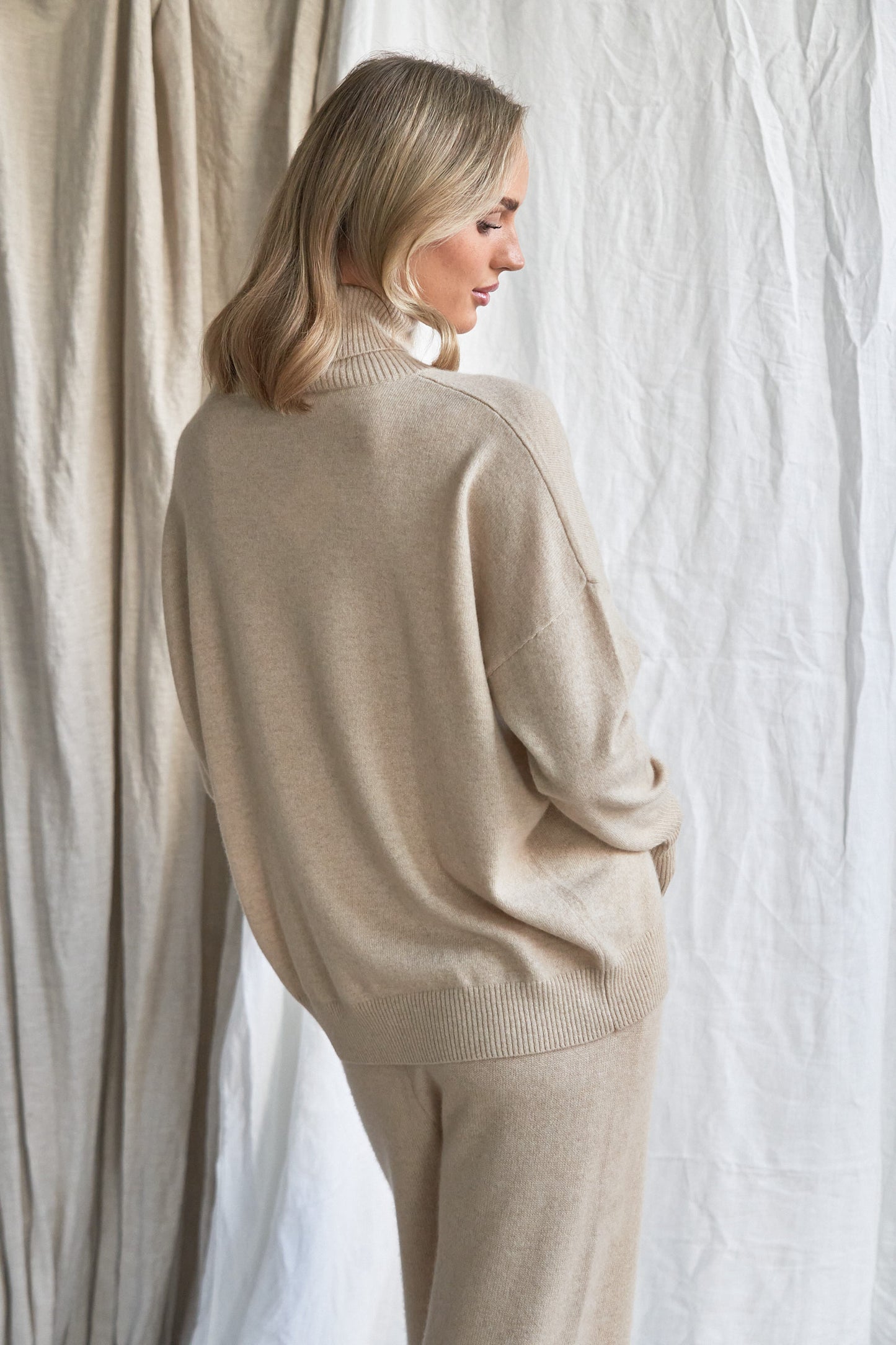 Indulge in the soft luxury of our oversized oatmeal cashmere sweater, designed with a high neckline and relaxed fit for all-day comfort. Made from 100% pure, ethically sourced cashmere, this roomy women’s knit features wide sleeves, drop shoulders, and a soft neutral hue that complements every wardrobe.

Perfect for layering or lounging, this high neck oversized sweater is a modern essential for effortless cold-weather dressing. Soft, breathable, and naturally insulating — it’s winter comfort with elevated 